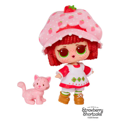 L.O.L. Surprise Loves Strawberry Shortcake scented Tot doll next to her pet cat and transforming Strawberry House playset capsule.