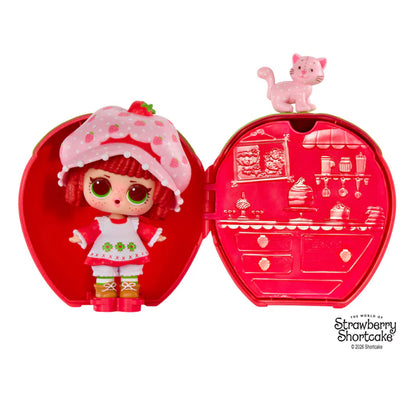 L.O.L. Surprise Loves Strawberry Shortcake scented Tot doll next to her pet cat and transforming Strawberry House playset capsule.