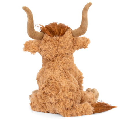 Bukowski Bears Henderson 12-inch highland cow plush sitting in the grass, featuring shaggy warm earthy-toned fur and curved horns.