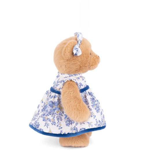 Bukowski Bears Lily 8-inch honey-tan plush bear wearing a blue-and-ivory floral dress with velvet trim and matching ear bows.