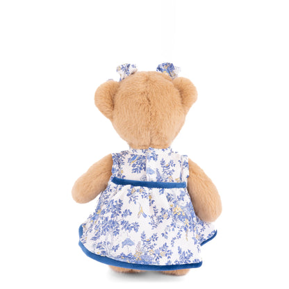 Bukowski Bears Lily 8-inch honey-tan plush bear wearing a blue-and-ivory floral dress with velvet trim and matching ear bows.