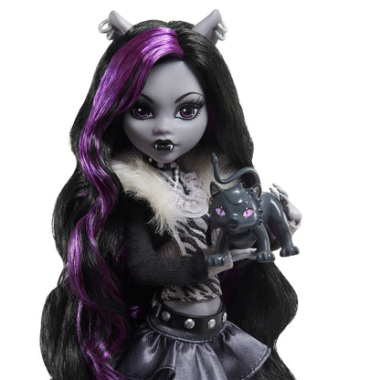 Monster High Reel Drama doll with purple hair and black outfit holding a black cat figurine on a white background