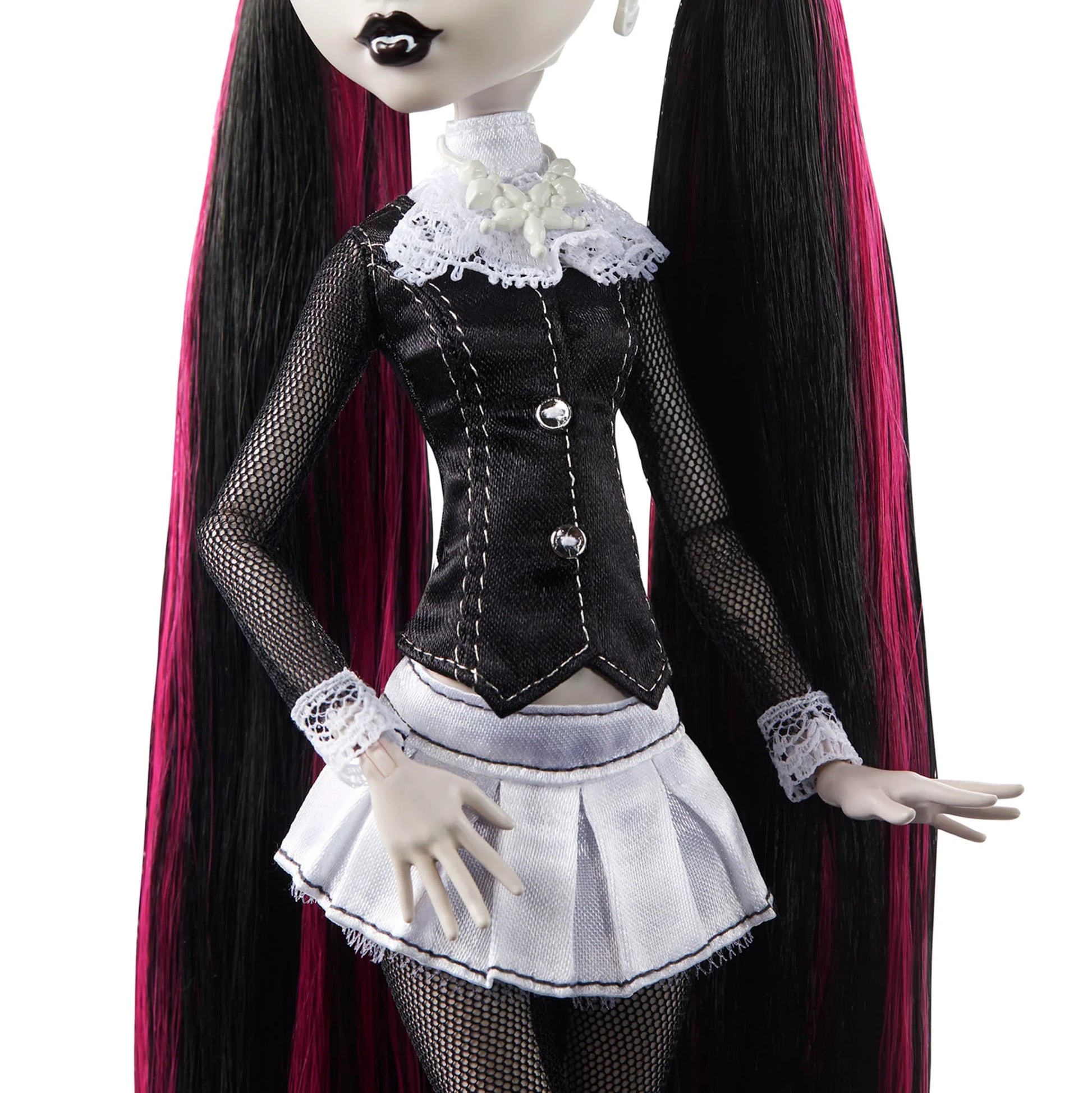 Gothic-style doll with long black hair and a black and white outfit on a white background