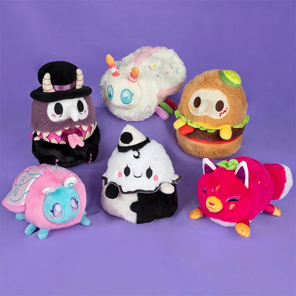 Set of colorful plush toys on a purple background