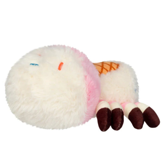 Squishable Alter Egos Series 20 Ice Cream Spider plush held in a hand, featuring fluffy white and pink fur, a waffle cone detail, and brown striped legs.