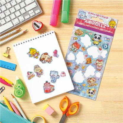 Sheet of stickers with cartoon characters on a notebook next to a pack of Anirollz stickers on a desk with stationery items.