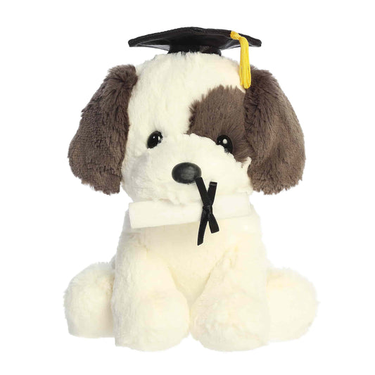 Product view of Aurora Graduation Terrier Pup plush with a brown eye patch, wearing a grad cap and holding a diploma.