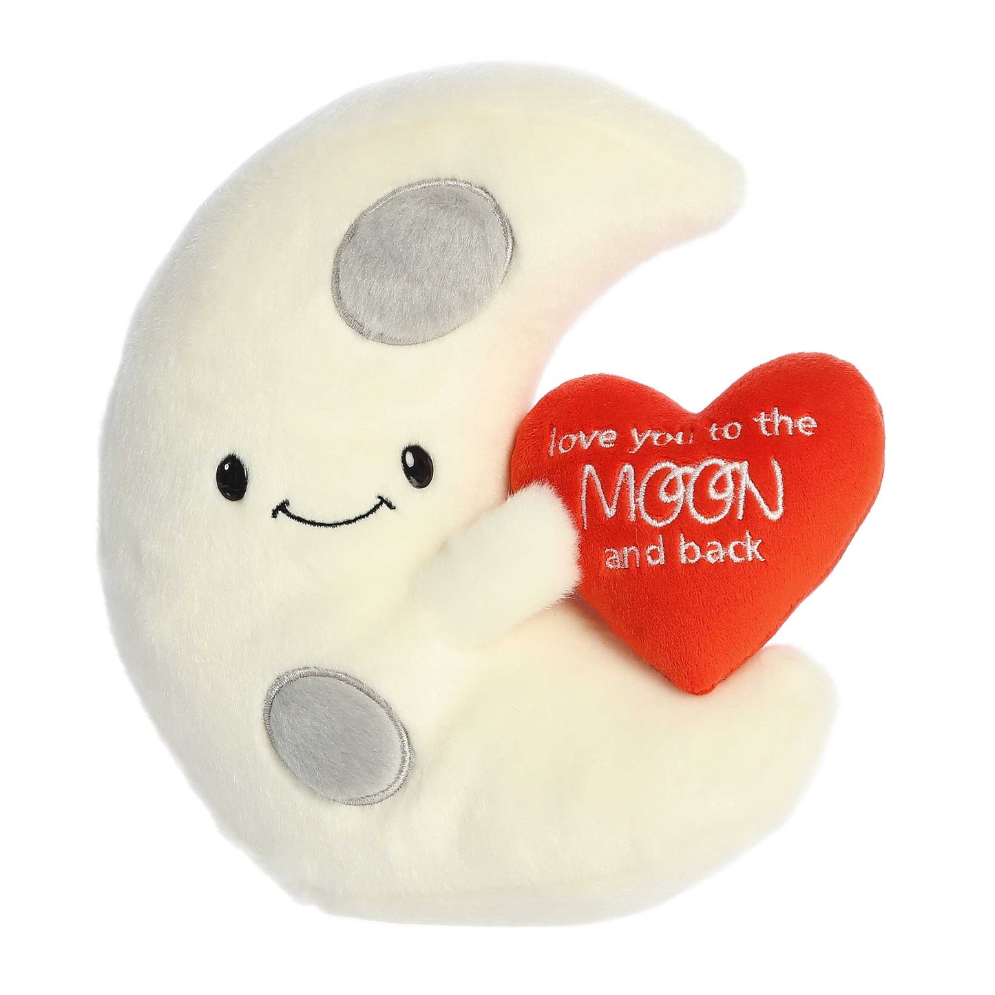 Product view of Aurora Just Sayin' plush, a white crescent moon holding a red heart that says love you to the moon and back.