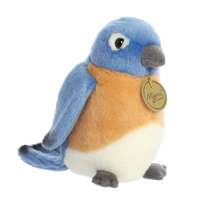 Aurora Miyoni Bluebird lifelike plush stuffed animal sitting with vibrant blue and orange plumage and soulful eyes.