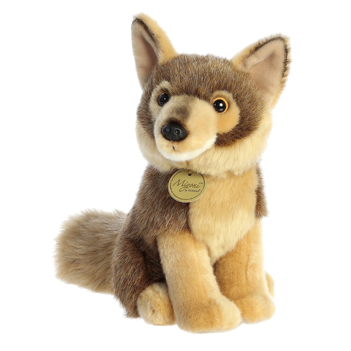 A product photo of the Aurora Miyoni Coyote 9.5-Inch Plush, a light and dark brown realistic coyote stuffed animal in a sitting pose, wearing a gold Miyoni tag.
