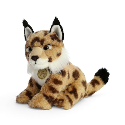 Aurora Miyoni Tots Lynx lifelike baby plush stuffed animal sitting with patterned spotted fur, pointed ears with black tufts, and a white chest.