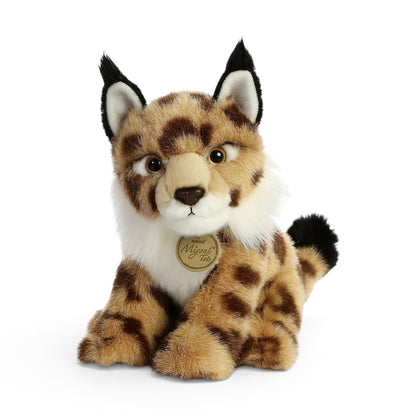 Aurora Miyoni Tots Lynx lifelike baby plush stuffed animal sitting with patterned spotted fur, pointed ears with black tufts, and a white chest.