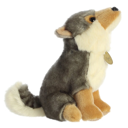 Aurora Miyoni Wolf lifelike plush stuffed animal sitting with gray and cream fur, amber eyes, and a fluffy tail.