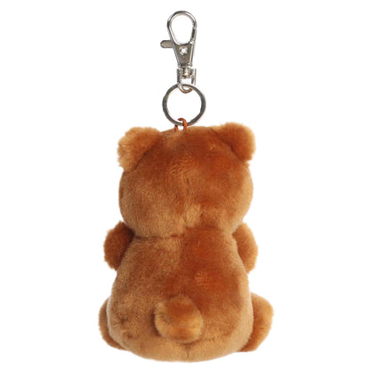 Aurora Palm Pals Artie Bear plush clip-on featuring soft chestnut-brown fur, a tan muzzle, dark eyes, and a silver swivel clasp.