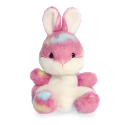 Product view of Aurora Palm Pals Buniberry Jellybean Bunny, a pink rabbit plush with tie-dye spots of blue and yellow and a white tummy.