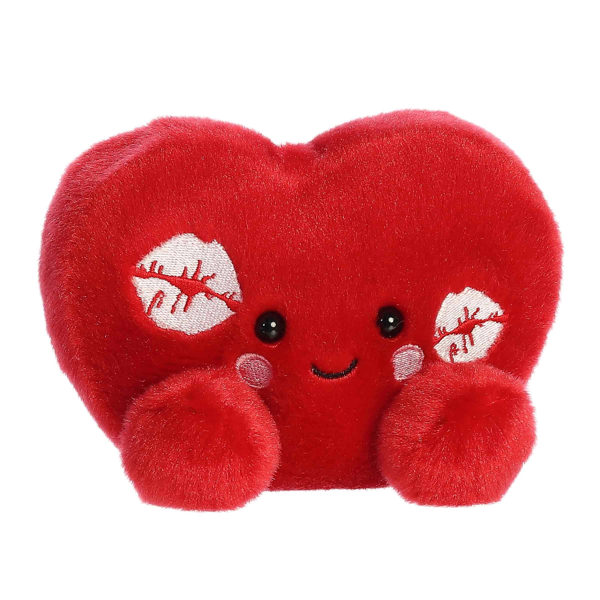 Angled view of Aurora Palm Pals Kimi Kisses Heart, a small 5-inch red plush.