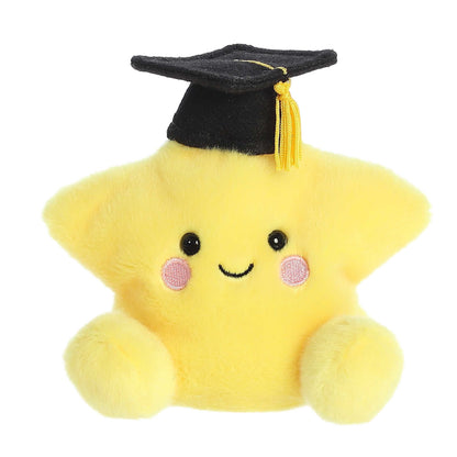 Product view of Aurora Palm Pals Magna Grad Star, a yellow plush star wearing a black graduation cap with a gold tassel.