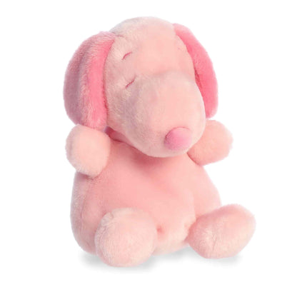 Product view of Aurora Palm Pals Peanuts Snoopy Pink, a small beagle plush with pink ears, nose, and spot, sitting in a relaxed pose.