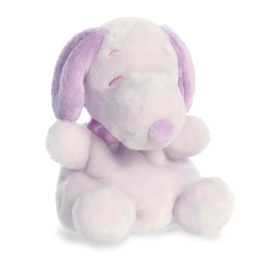 Product view of Aurora Palm Pals Peanuts Snoopy Purple, a small beagle plush with lavender ears and spot, sitting in a relaxed pose.