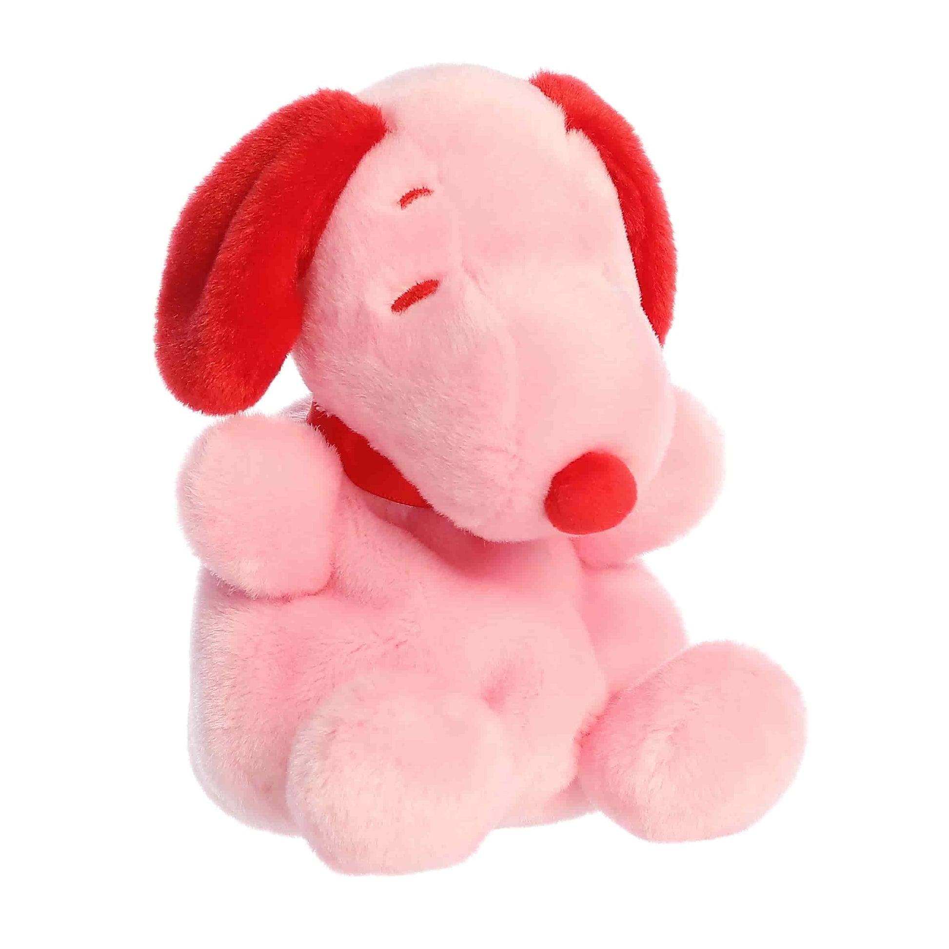 Product view of Aurora Palm Pals Peanuts Snoopy Red & Pink Valentine's Day plush featuring pink fur, red ears, and a red ribbon.
