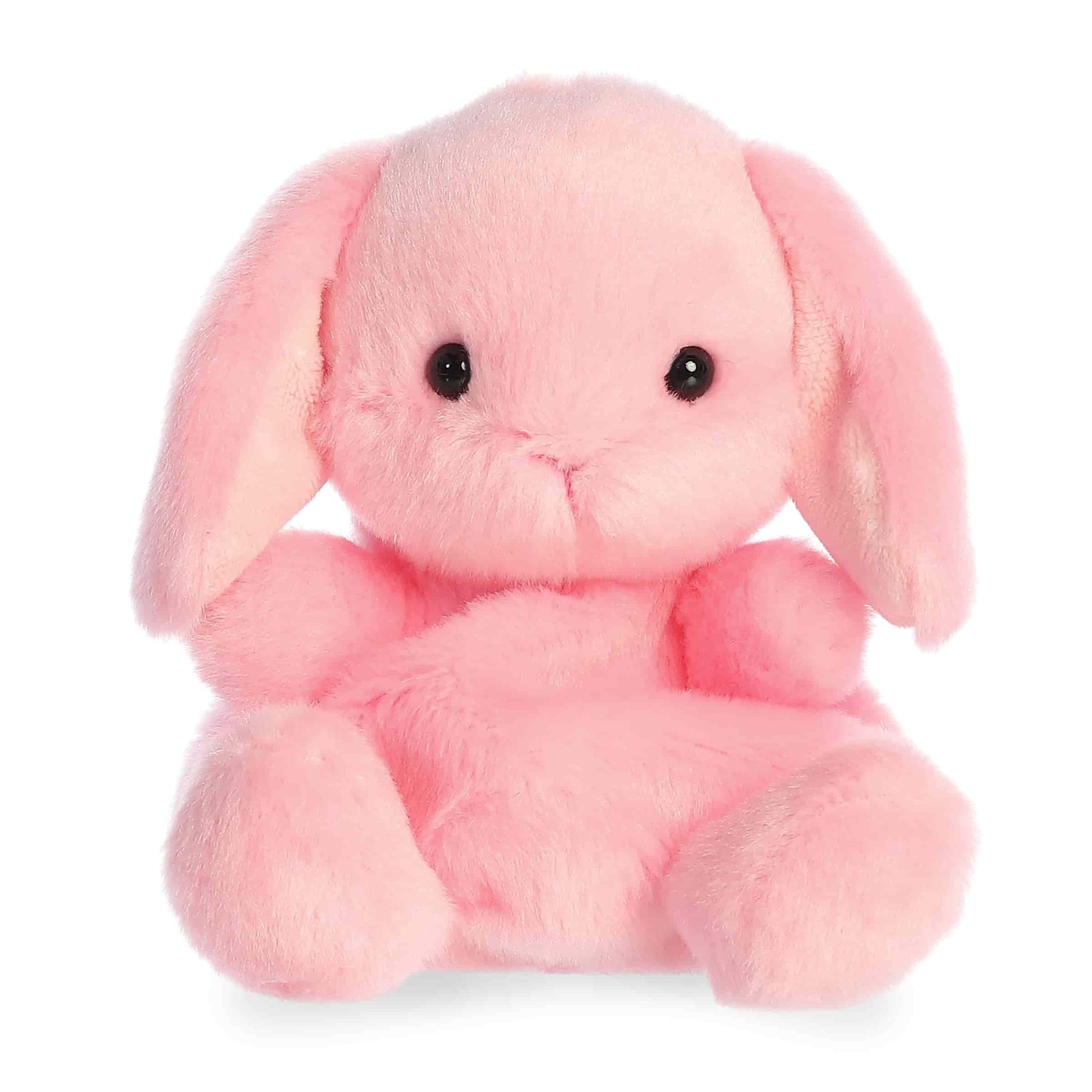 Product view of Aurora Palm Pals Petal Pink Lop Bunny, a soft pink rabbit plush with long floppy ears and a sitting pose.