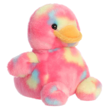 Aurora Palm Pals Shimmer Rubber Ducky plush animal featuring bright pink tie-dye fur with pastel spots, an orange bill, and dark eyes sitting upright.