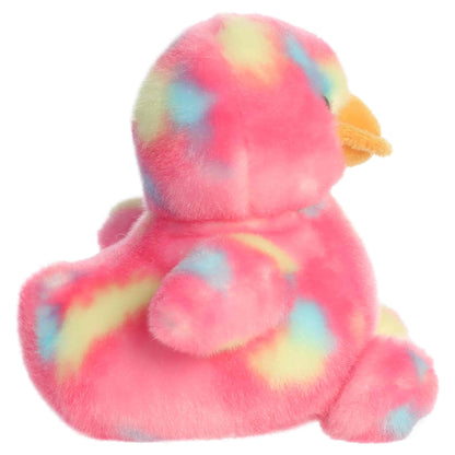 Aurora Palm Pals Shimmer Rubber Ducky plush animal featuring bright pink tie-dye fur with pastel spots, an orange bill, and dark eyes sitting upright.