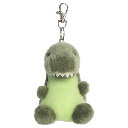 Aurora Palm Pals Tyranno Rex plush clip-on featuring soft green fur, light green belly, felt teeth, and a silver swivel clasp.