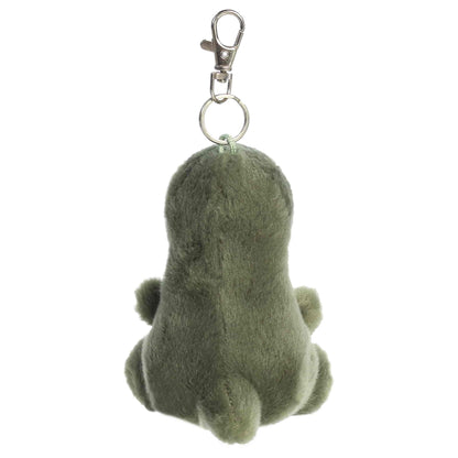 Aurora Palm Pals Tyranno Rex plush clip-on featuring soft green fur, light green belly, felt teeth, and a silver swivel clasp.
