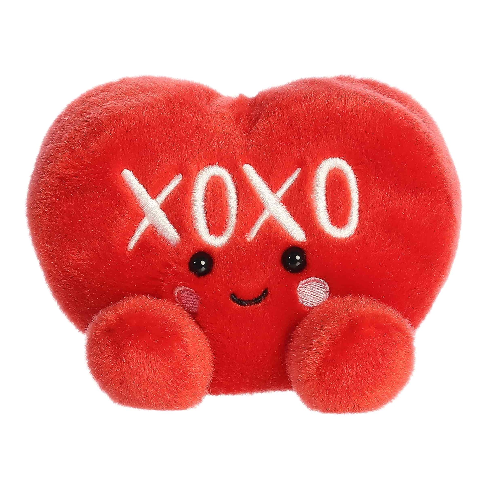 Product view of Aurora Palm Pals XOXO Candy Heart, a small red plush heart with white embroidered text.