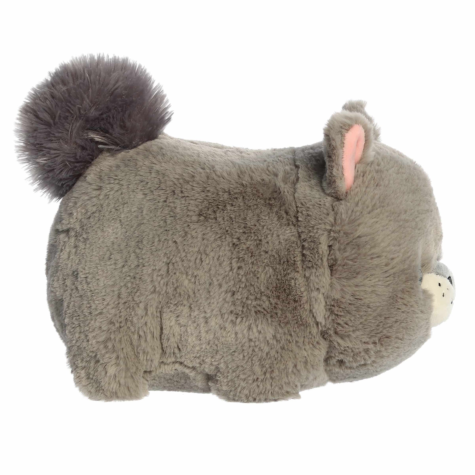 Side view of A product photo of the 10-inch Aurora Spudsters Gabby Gray Squirrel, a gray, potato-shaped plush squirrel with a bushy tail and pink inner ears.