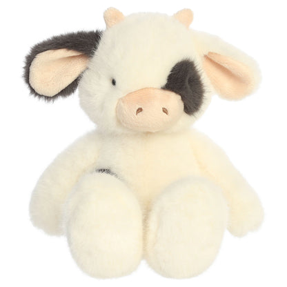 Aurora The Thicket Tales 12-inch Clover Cow plush toy featuring soft eggshell fur, dark spots, and delicate pink ears.