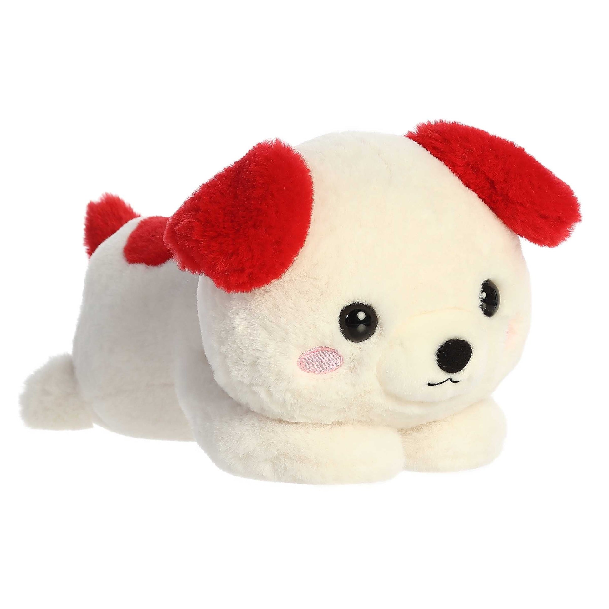 A product photo of the 9-inch Aurora Too Cute Doodle Dog plush, a white dog with red ears, shown lying belly-down with its paws sprawled out on a white background.