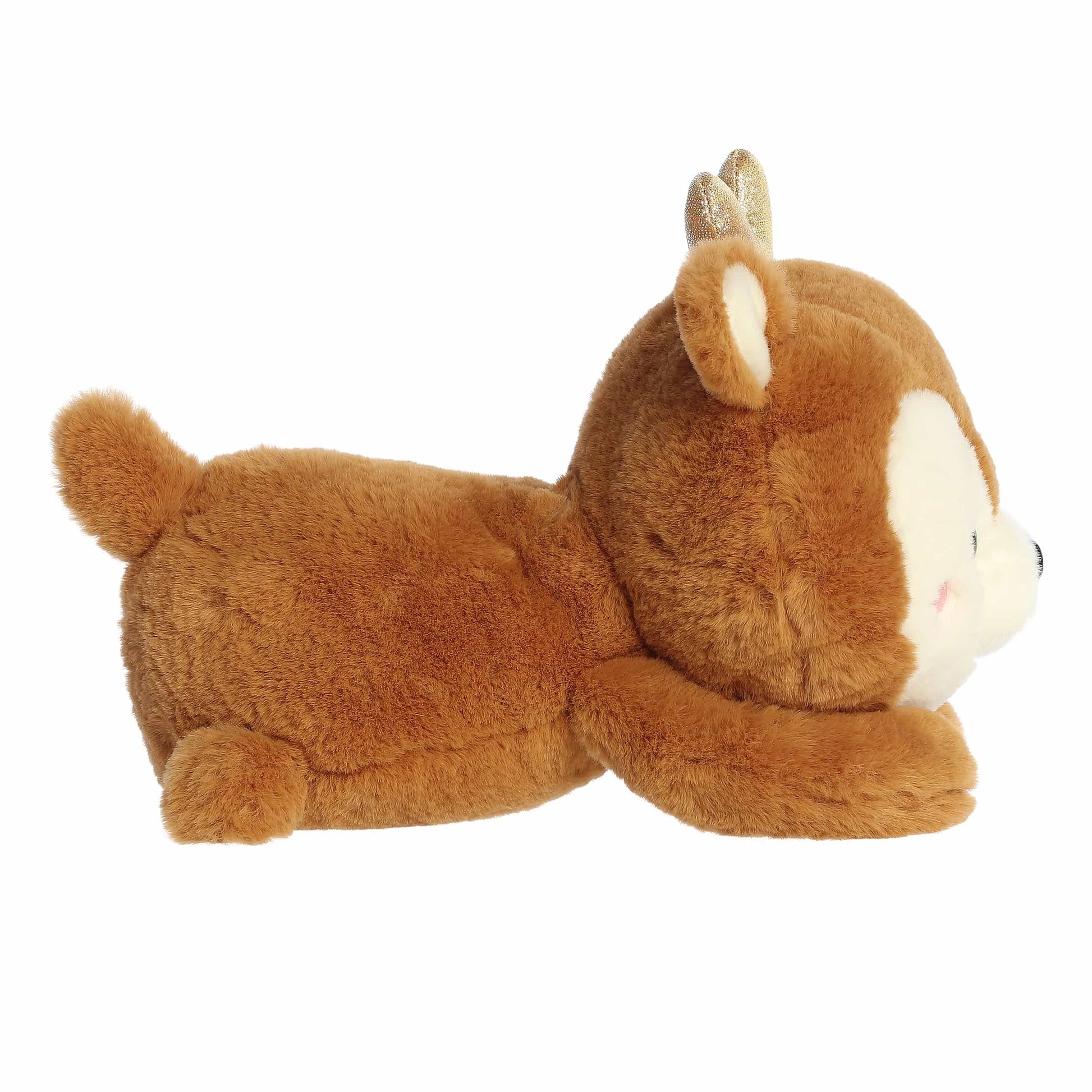 Aurora Too Cute Rene Reindeer plush lying belly-down featuring soft brown fur, a white muzzle, rosy cheeks, and shimmering gold glitter antlers.