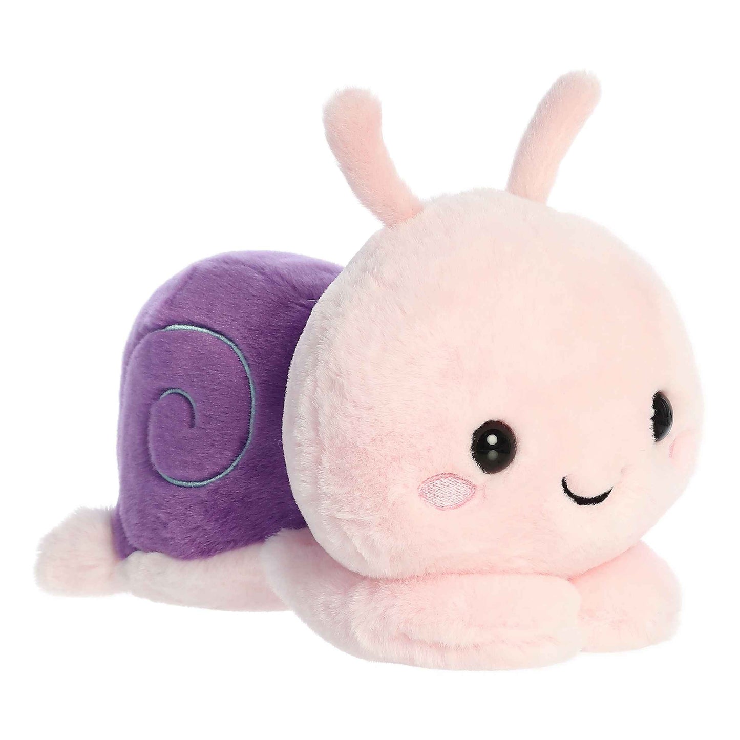 A product photo of the 9-inch Aurora Too Cute Sena Sea Snail plush, a pink snail with a purple shell, shown lying belly-down with its paws sprawled out on a white background.