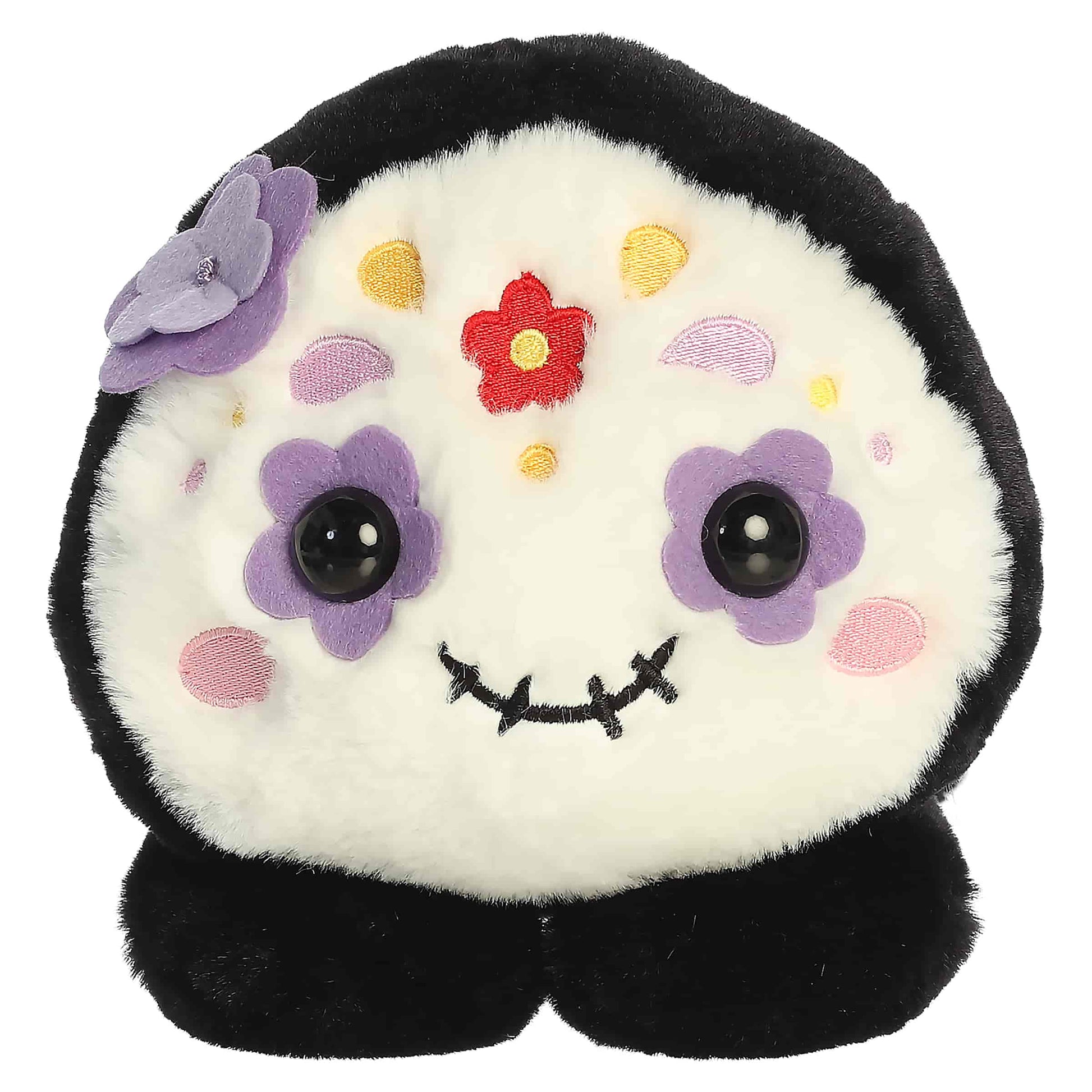 Aurora Too Cute Sissy Sugar Skull plush lying belly-down featuring a white face with colorful embroidered floral patterns and a purple 3D flower.