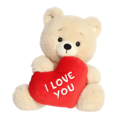 Product view of Aurora Valentine Beary Sweet Bear plush, a cream teddy bear holding a red heart that says I Love You.