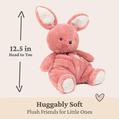 Pink plush toy with measurement text on a light background