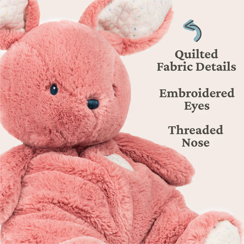 Pink plush toy with quilted fabric details on a white background