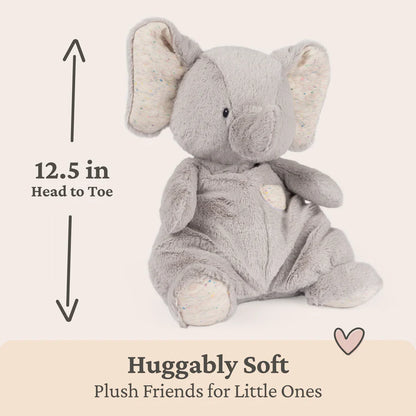 Gray plush elephant toy with measurement label and 'Huggably Soft' text on a beige background