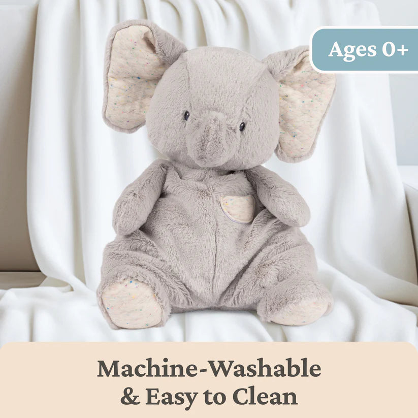 Plush elephant toy on a white background with text indicating machine-washability and age suitability.