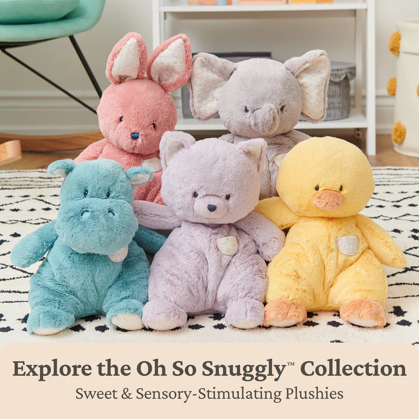 Five plush toys in different colors on a patterned rug with text promoting the 'Oh So Snuggly' collection.