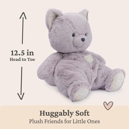 Lavender Kitten teddy bear with measurement text and 'Huggably Soft' label on a beige background
