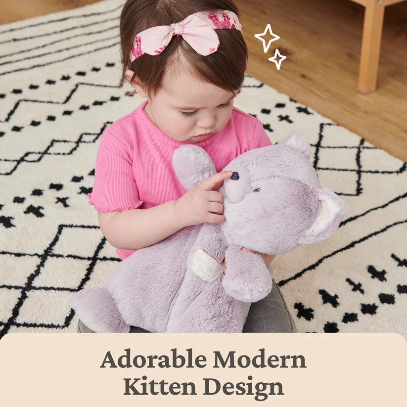 Child holding a plush toy with text 'Adorable Modern Kitten Design' on a patterned rug.