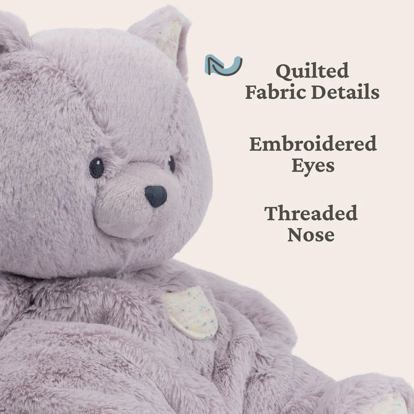 Lavender Kitten teddy bear with quilted fabric details, embroidered eyes, and a threaded nose on a light gray background.