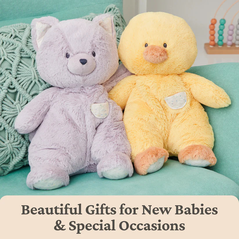 Two plush toys, a purple bear and a yellow duck, sitting on a teal surface with text 'Beautiful Gifts for New Babies & Special Occasions'.