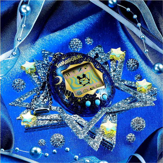 A blue Tamagotchi toy with a glittery space theme, surrounded by silver star-shaped accessories, iridescent stars, and blue beads on a shiny royal blue fabric background.