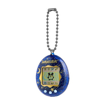 A Tamagotchi handheld electronic pet toy keychain in a deep blue space theme with gold glitter stars, attached to a silver ball chain, shown on a solid white background.