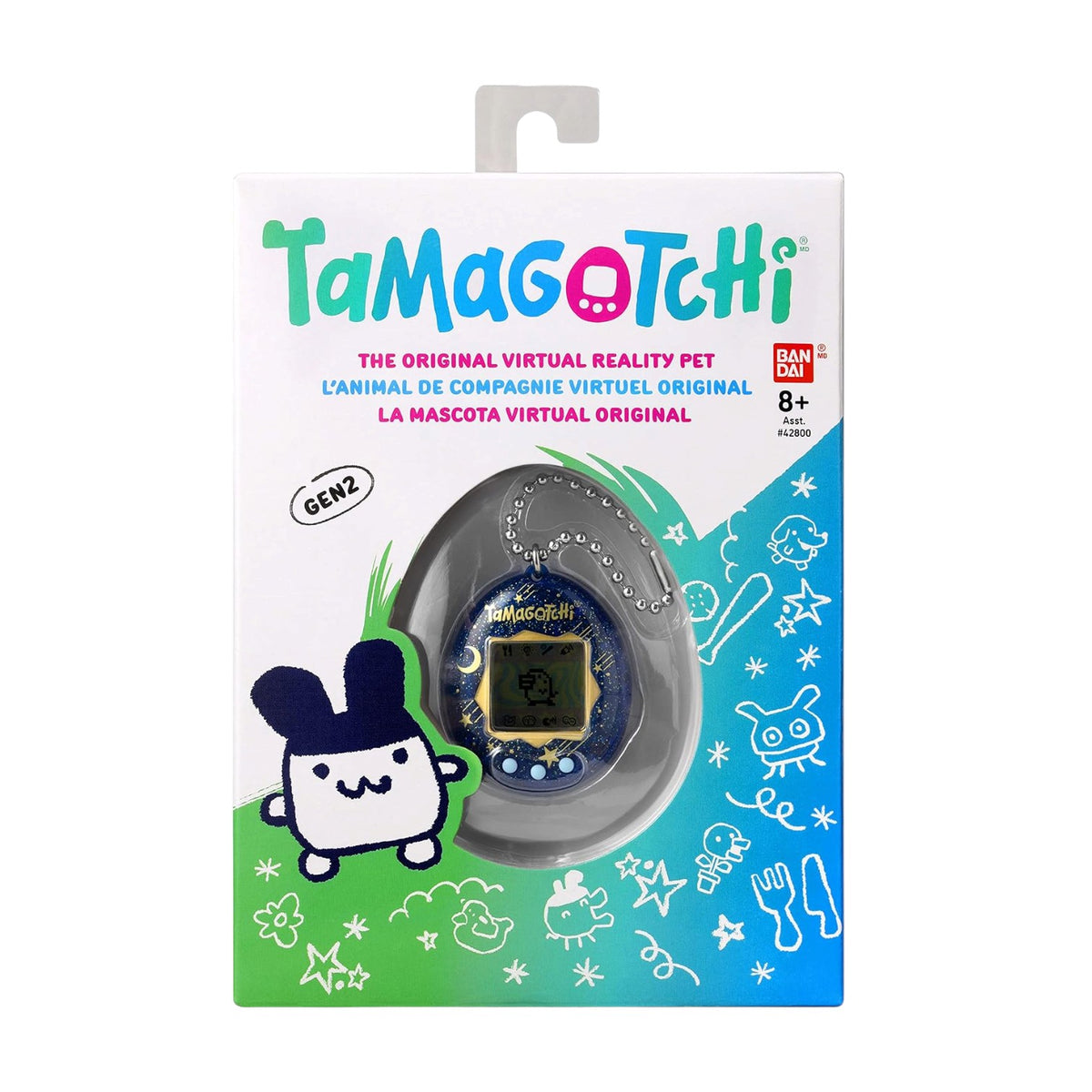 Tamagotchi Gen2 virtual reality pet toy in its original retail packaging, featuring the blue and yellow toy inside a clear dome on a white, green, and blue illustrated card backing.