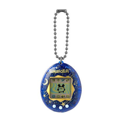 A Tamagotchi handheld electronic pet toy keychain, featuring a blue starry shell with gold stars and the Tamagotchi logo, attached to a silver ball chain.